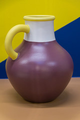 Bright ceramic multi-colored jug. Bright background. Art.