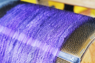 Felting wool. Combing the wool of alpaca or llama before felting on a special machine with a drum...