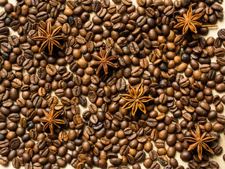 Coffee background of coffee beans and anise stars, copy space, top view.