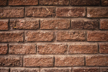 Textured background of antique decorative brick with easy vignetting. Medieval background for a brick wall