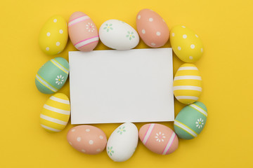 Easter holiday background. Pastel coloured decorated easter eggs with a blank white label.