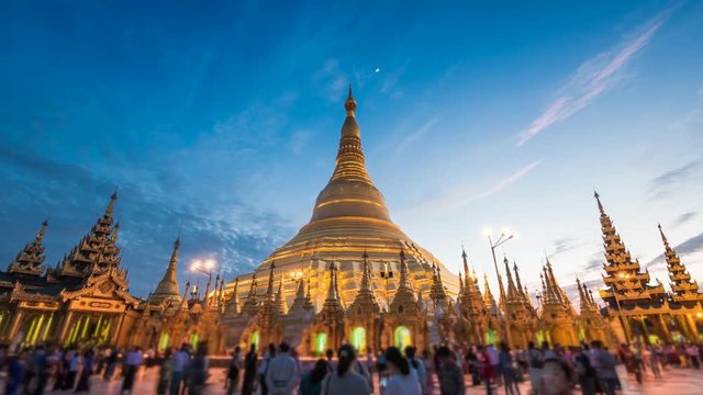 Shwedagon Pagoda in Yangon, Myanmar (Burma), time lapse view of the famous Buddhist landmark at sunset. Zoom in.