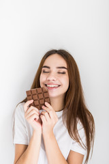 Young woman snacking on a bar of chocolate