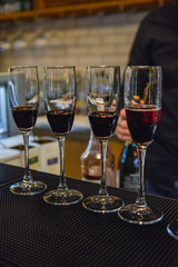 Wine pouring into the glasses on bar