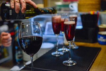 Wine pouring into the glasses on bar