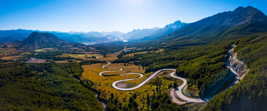 Aerial panorama of the curved asphalt road trough mountains. Carretera Austral road near the Cerro Castillo National Park. Chile