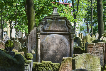 Fototapeta na wymiar Tombstones on Old Jewish Cemetery in the Jewish Quarter in Prague.There are about 12000 tombstones presently visible. One of the most important Jewish monument