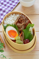 Bento is a Japanese takeaway lunch served in a box, often with the food arranged into an elaborate design. A traditional bento holds rice or noodles, fish or meat, with pickled and cooked vegetables.