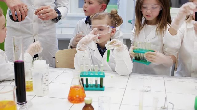 Group of children making science experiments. Education.