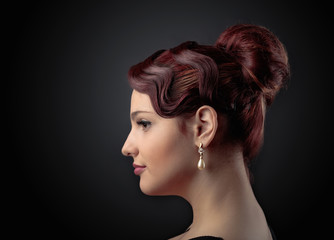 Portrait of a beautiful woman with perfect hair and  pearl earrings .