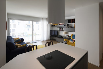 Detail of kitchen with a view of the living room
