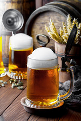 Light foam beer in a glass on an old background