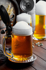 Light foam beer in a glass on an old background