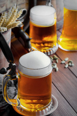 Light foam beer in a glass on an old background