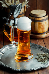 Light foam beer in a glass on an old background