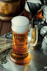 Light foam beer in a glass on an old background