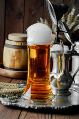 Light foam beer in a glass on an old background