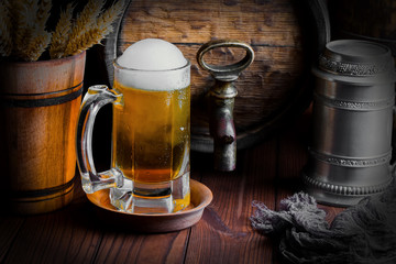 Light foam beer in a glass on an old background