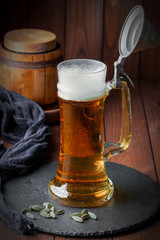 Light foam beer in a glass on an old background