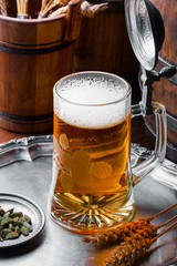 Light foam beer in a glass on an old background