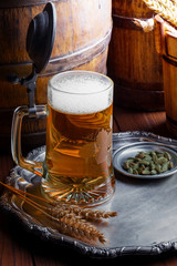 Light foam beer in a glass on an old background