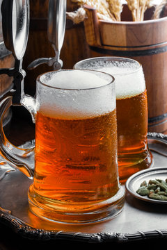 Light foam beer in a glass on an old background