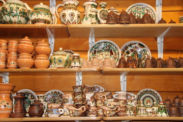 Earthenware on the shelves of shop. Ceramic goods. Products of ceramics on sale