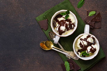 Vanilla ice cream with chocolate chips and hot chocolate sauce. Summer cold dessert.