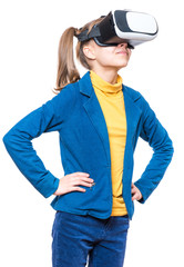 Happy little girl wearing virtual reality goggles watching movies or playing video games. Cheerful smiling teenager looking in VR glasses. Funny child experiencing 3D gadget technology - close up.