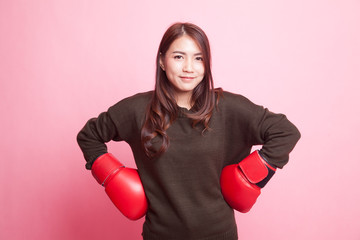 Young Asian woman with red boxing gloves.