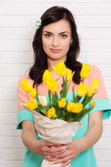 A woman holds out a bouquet