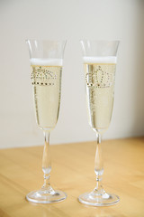 Two wedding decorated transparent glasses with champagne for the king and queen