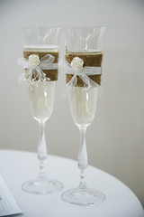 beautiful decorated with flowers and thread wedding glasses with champagne
