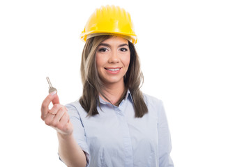 Portrait of female constructor showing one key.