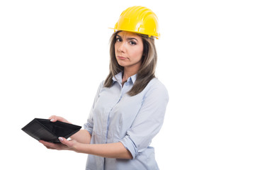 Sad female constructor looking showing her empty wallet.