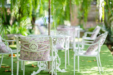 White chair in green garden.