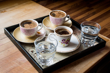 Turkish Coffee served with water in tray.