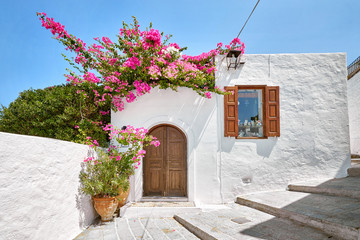 Facade of traditional white house in Lindos town at Rhodes island - obrazy, fototapety, plakaty