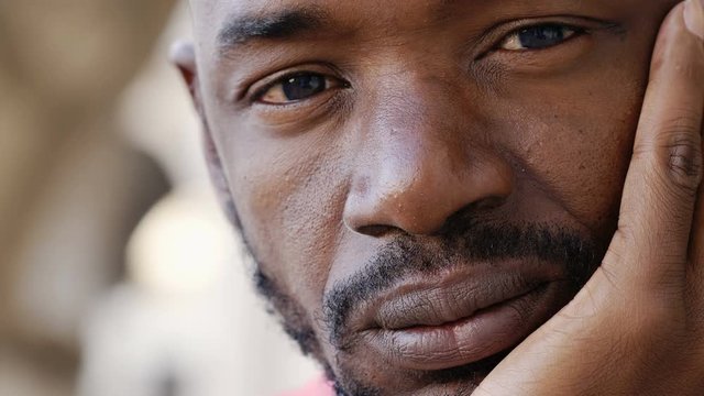 Pensive look of a young African black man- close up