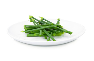 fresh Allium tuberosum in white plate isolated on white background