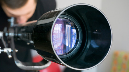 Man looking in telescope