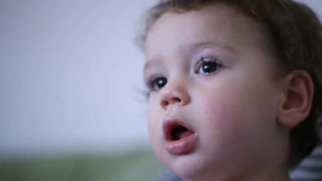 Cute boy doing absorbed look and having his mouth open
