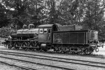 Fototapeta na wymiar Old steam locomotive standing on some old railroad track