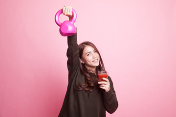 Healthy Asian woman with kettlebell and  tomato juice.