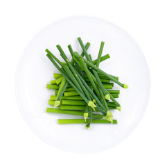 fresh Allium tuberosum in white plate isolated on white background