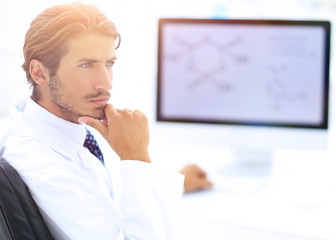 Scientist using computer and microscope in the laboratory