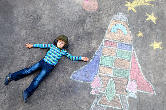 little kid boy flying by a space shuttle chalks picture