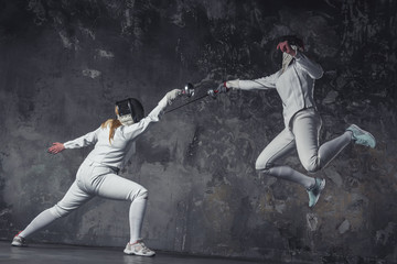 Fototapeta na wymiar Two women fencing