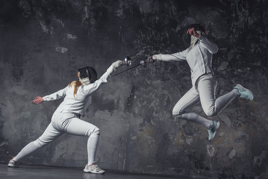 Two women fencing
