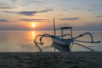 Beautiful sunrise with boats in Sanur beach, Bali, Indonesia